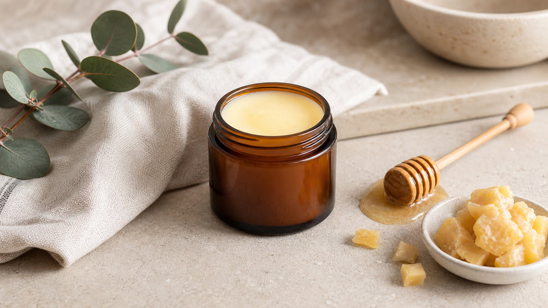 Grass-fed tallow balm Australia flat lay with amber balm jar, honey dipper and beeswax