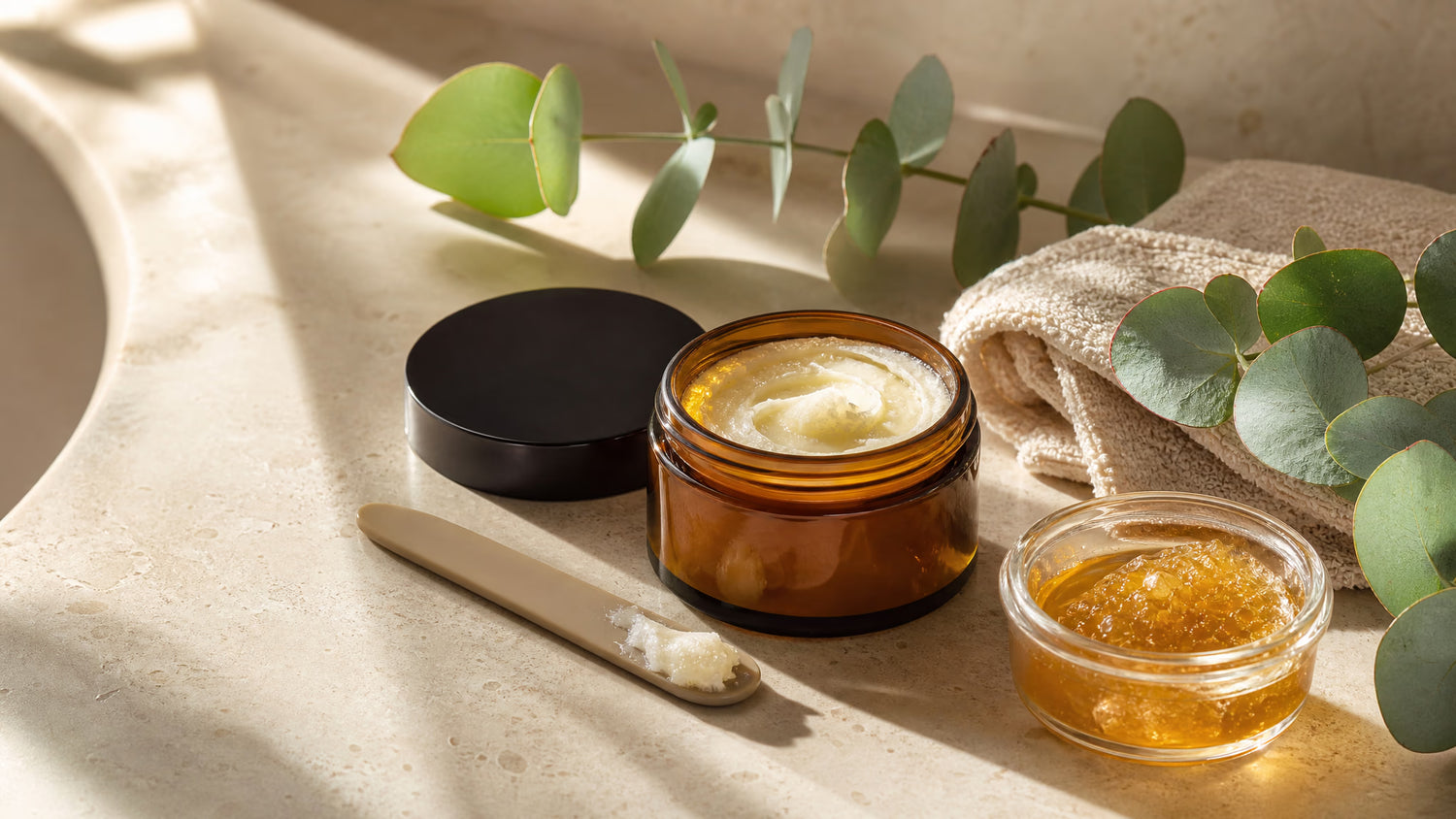 Tallow skincare balm with raw honey and eucalyptus on a neutral bathroom counter