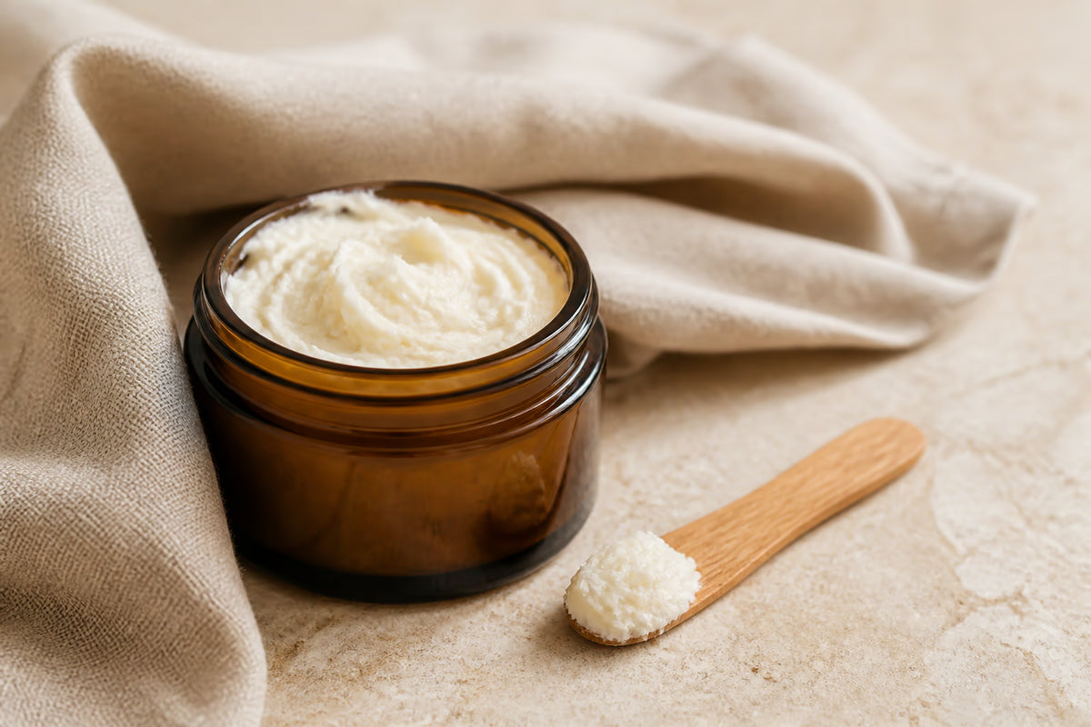 Open amber jar showing the airy texture of whipped tallow balm